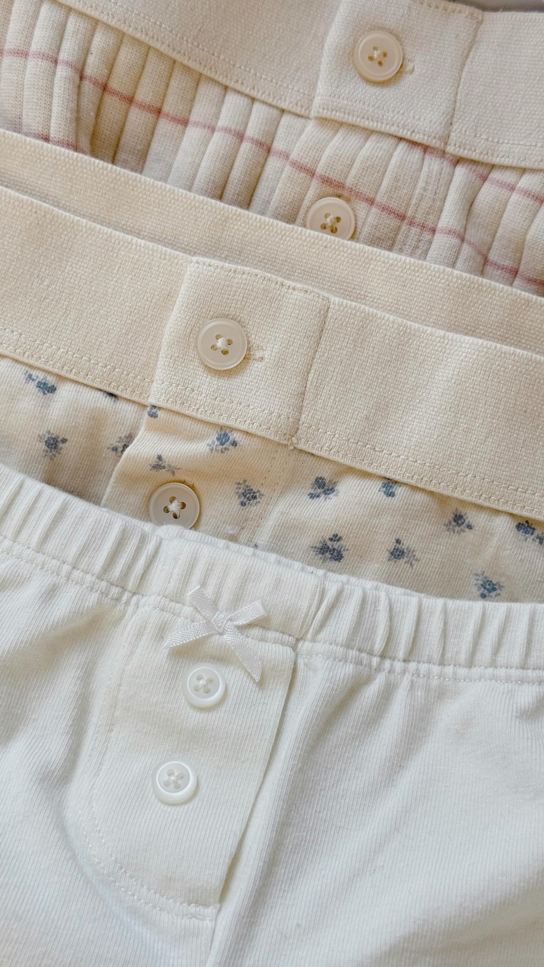 Close up image of three stacked pairs of womens undergarments 