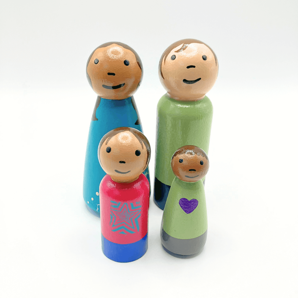 Colorful wooden family figurines on a white background
