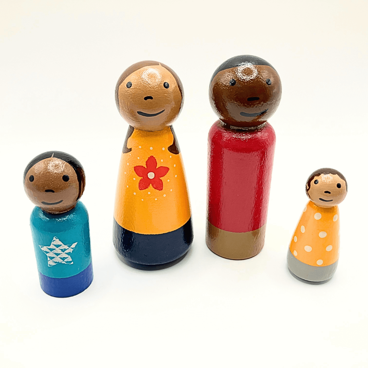 Set of colorful wooden dolls with different hairstyles and outfits on a white background