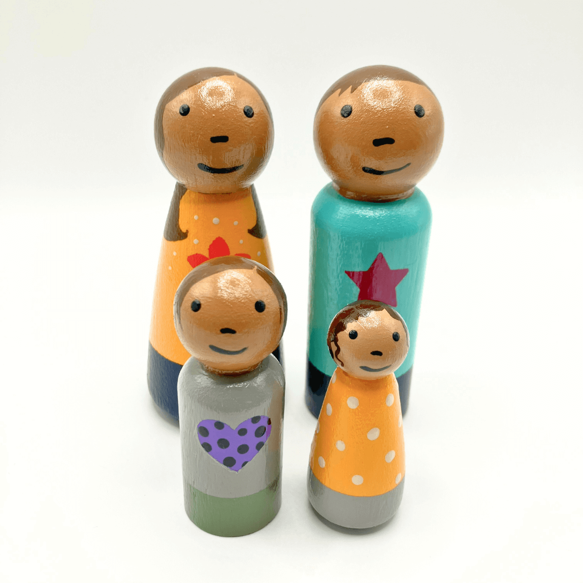 Set of wooden family figurines with colorful designs on a white background