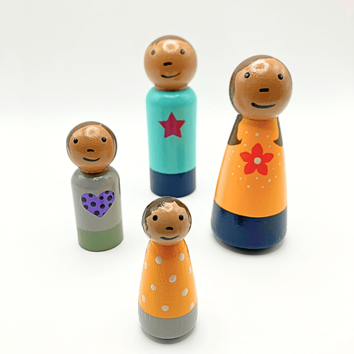 Set of colorful wooden peg dolls with different designs on a white background