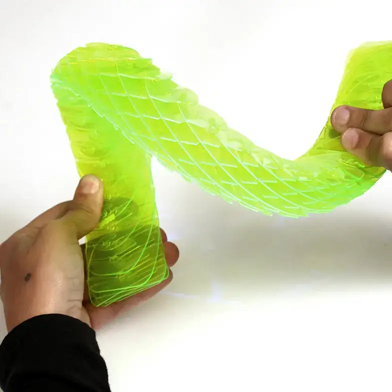 Person holding a bright green, wavy silicone product on a white background