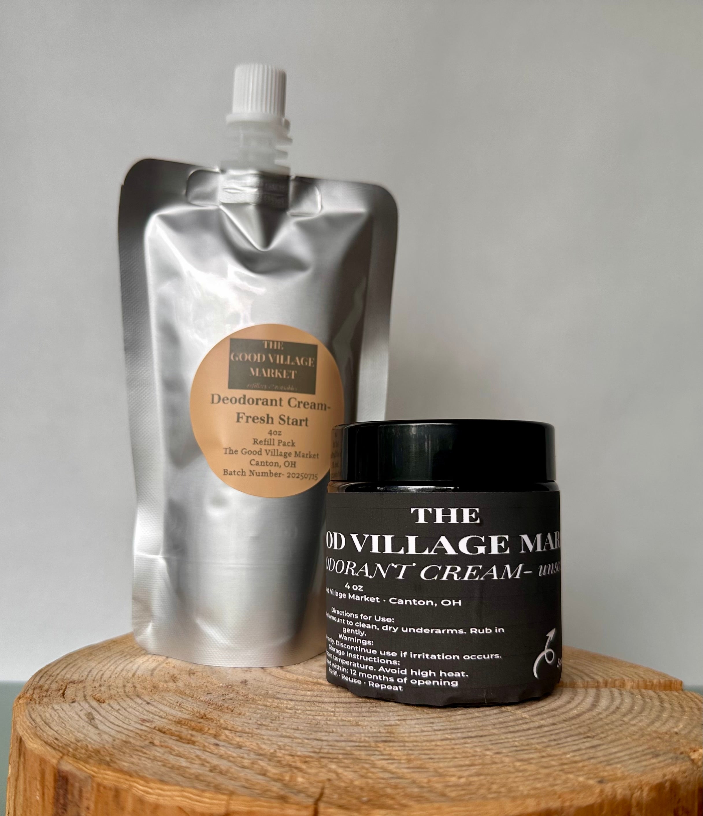 Deodorant cream packaging from 'The Good Village Market' on a wooden surface with a neutral background.