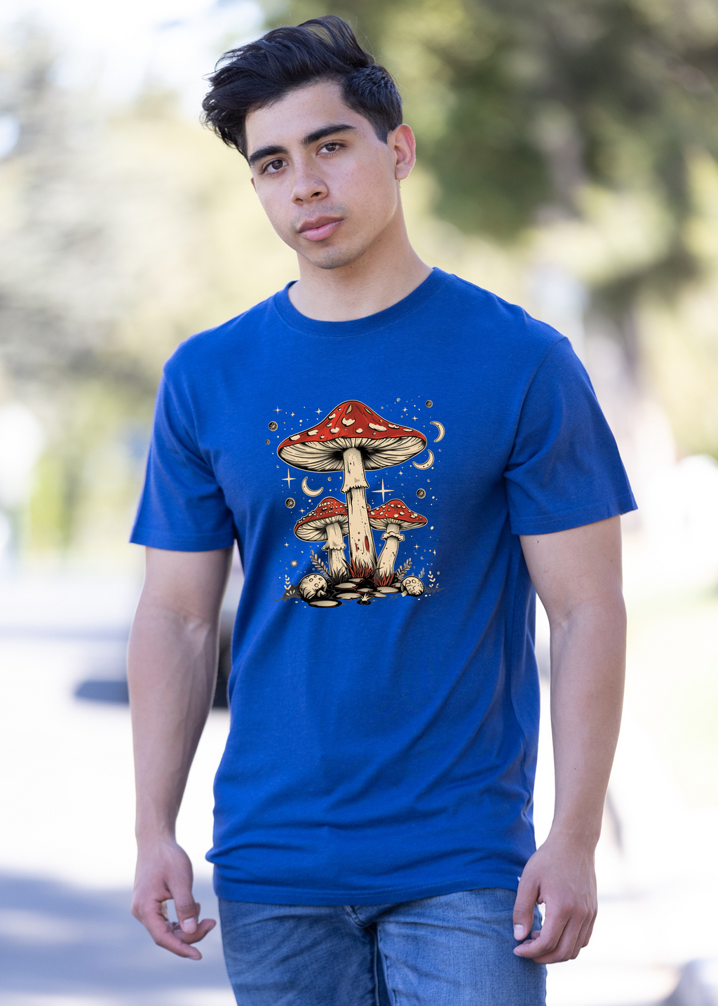 Person wearing a blue t-shirt with a mushroom graphic outdoors
