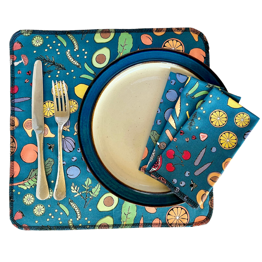 Colorful table setting with a plate, knife, fork, and napkin on a matching placemat.