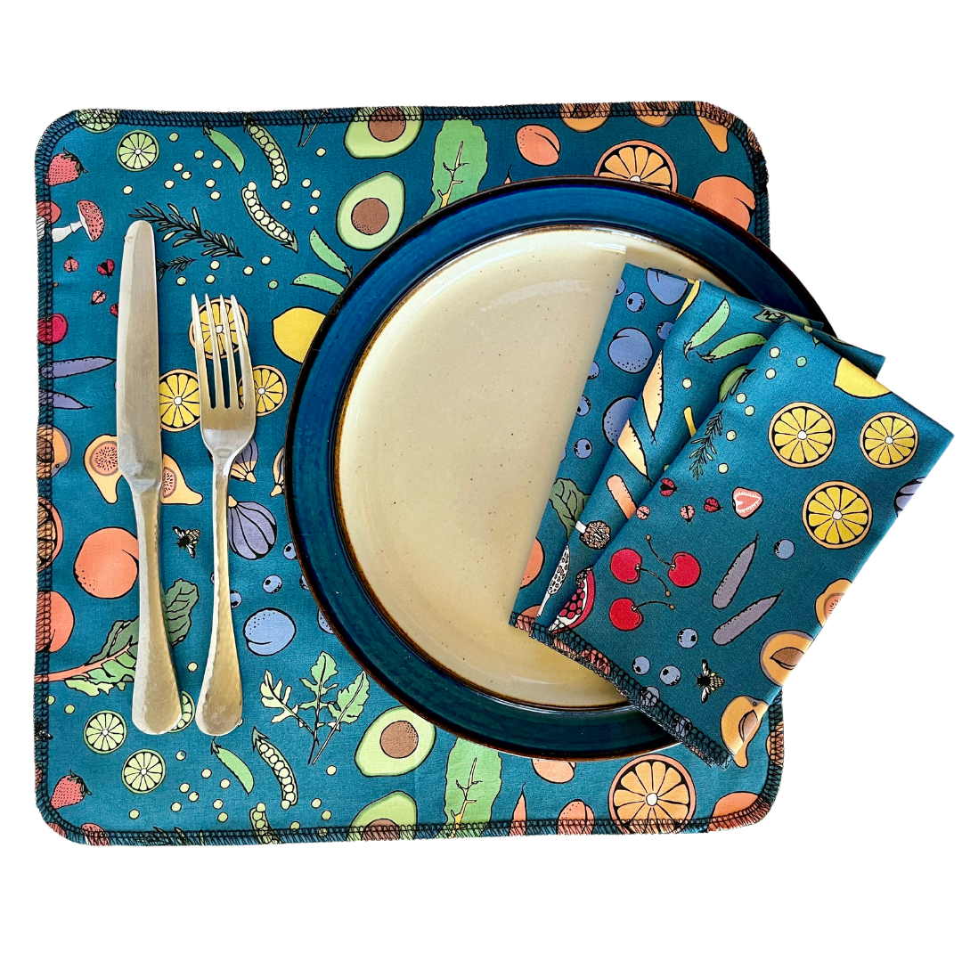 Colorful table setting with a plate, knife, fork, and napkin on a matching placemat.