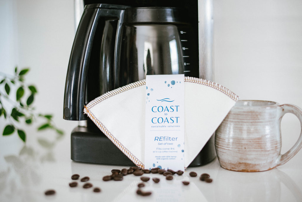 Coast to Coast coffee filter with a coffee maker and mug on a countertop