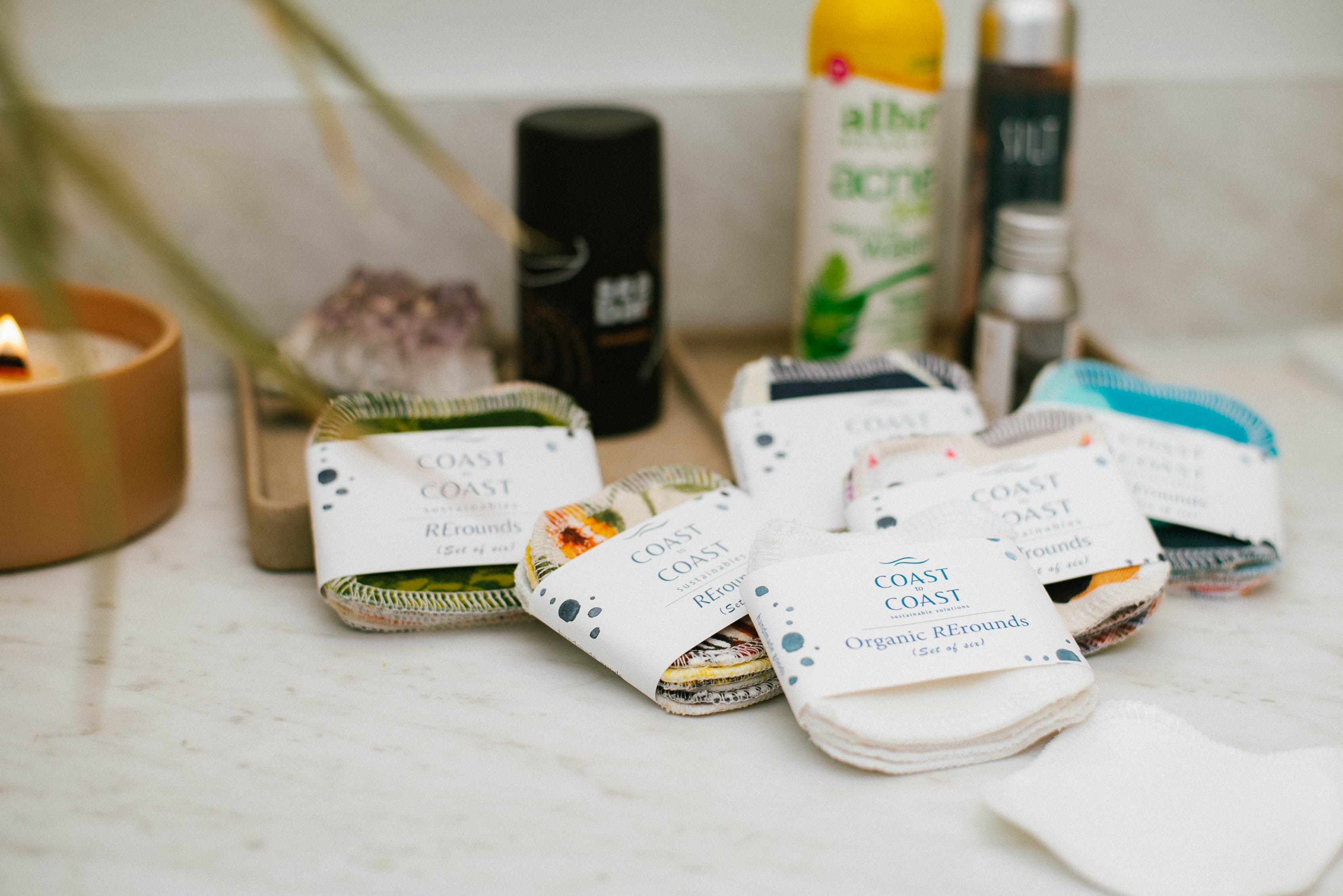 Multiple packages of 'Coast to Coast' on a bathroom counter with various skincare products in the background.