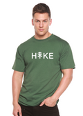 Person wearing a green t-shirt with 'Hike' printed on it against a white background