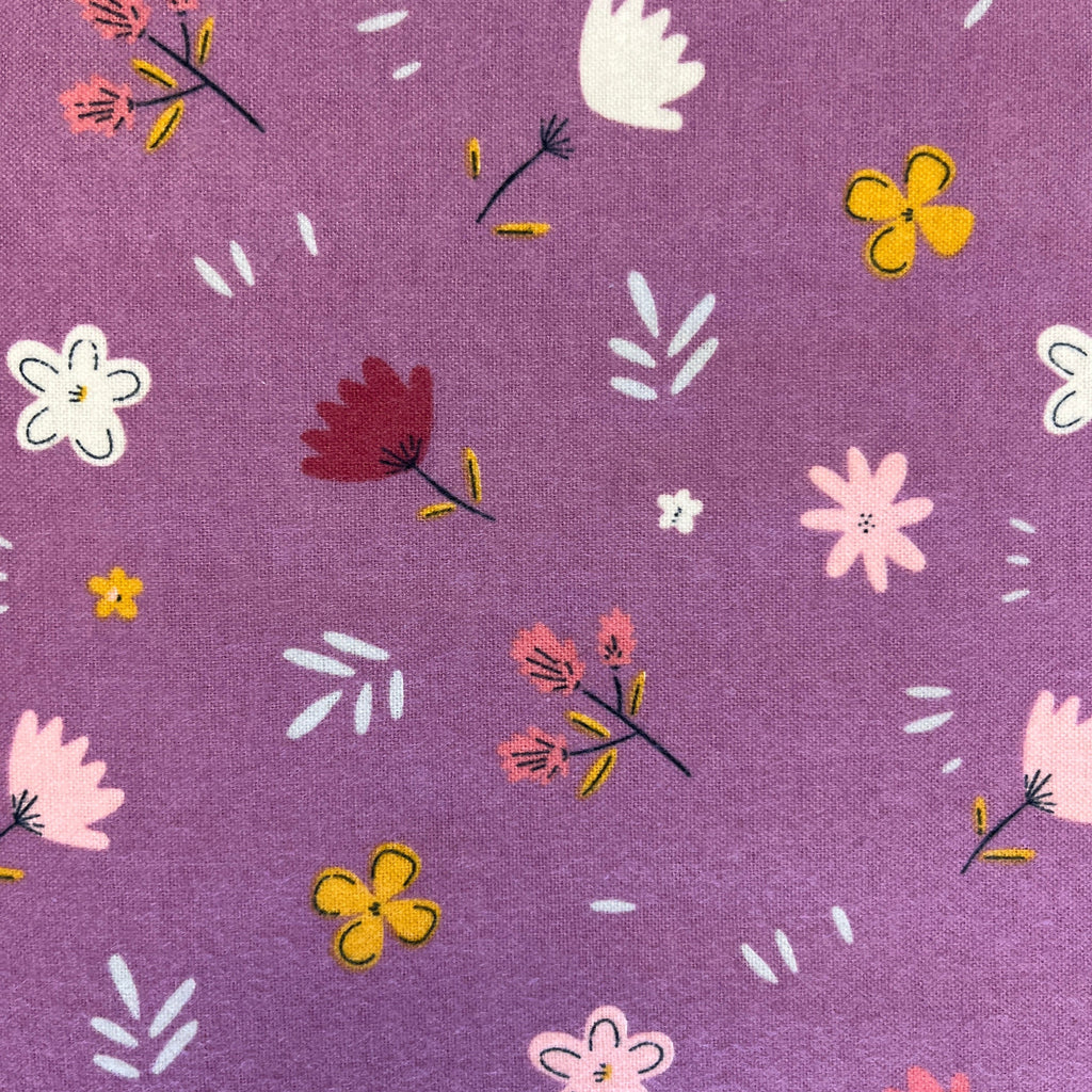 Floral pattern on a purple fabric background