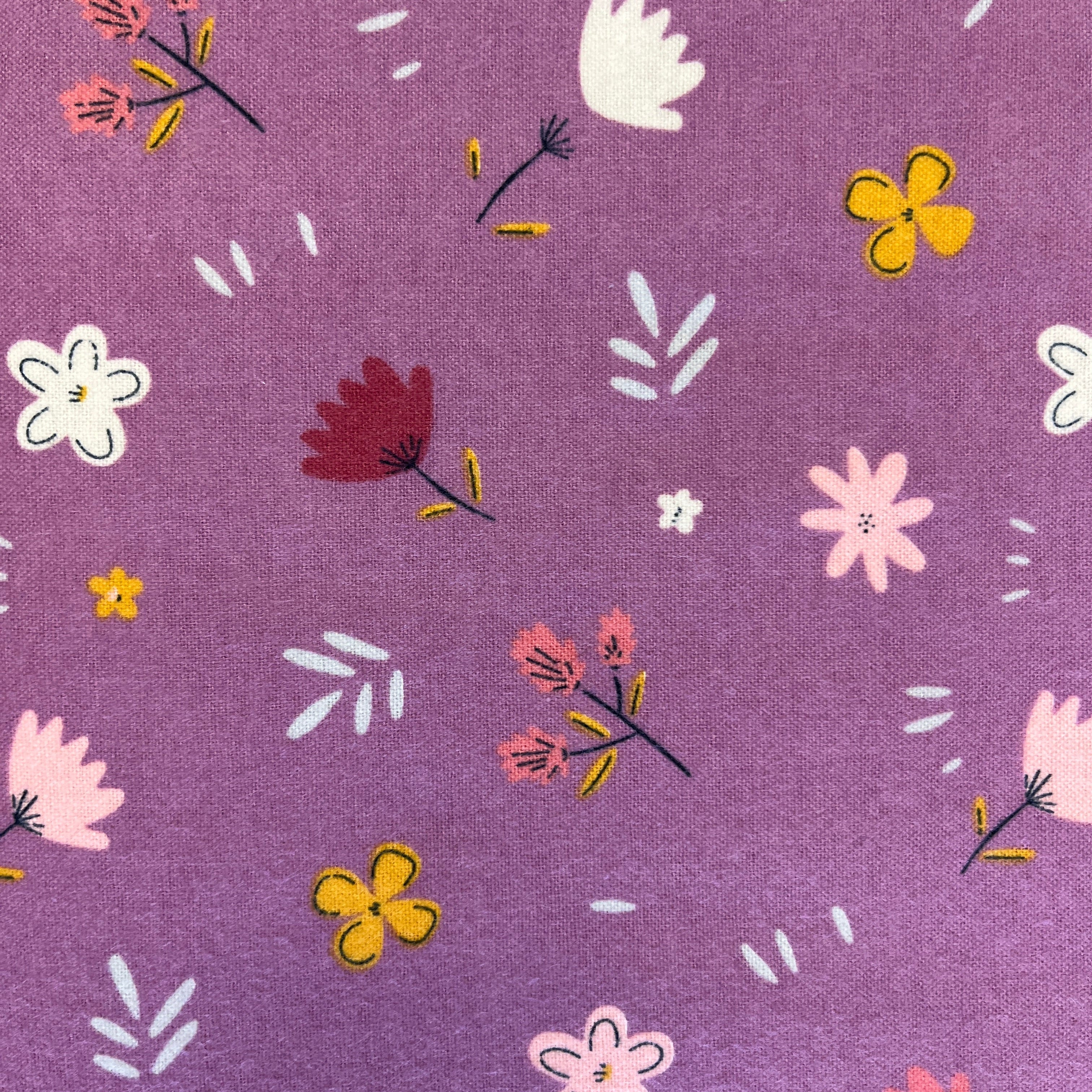 Floral pattern on a purple fabric background
