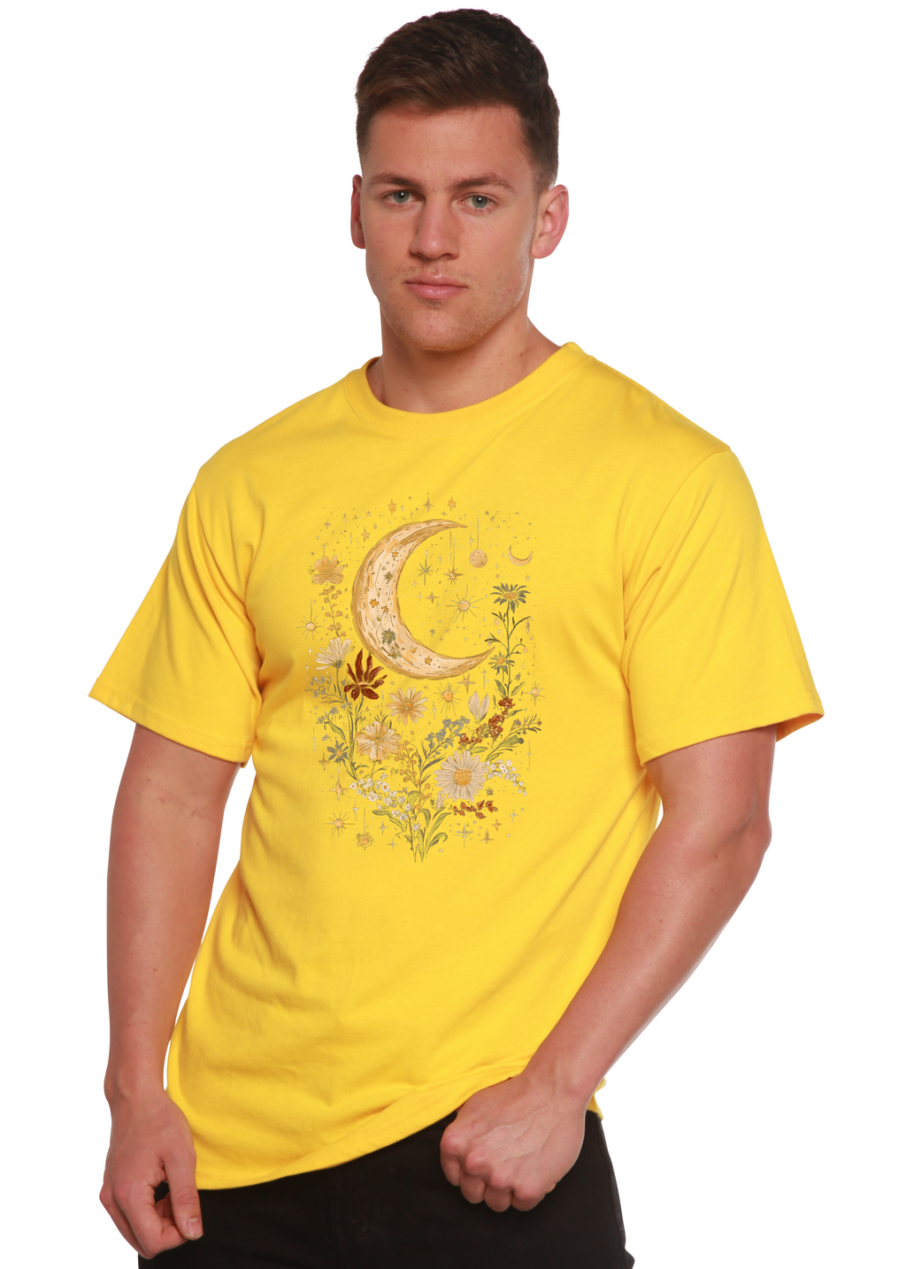 Person wearing a yellow t-shirt with a moon and floral design on a white background
