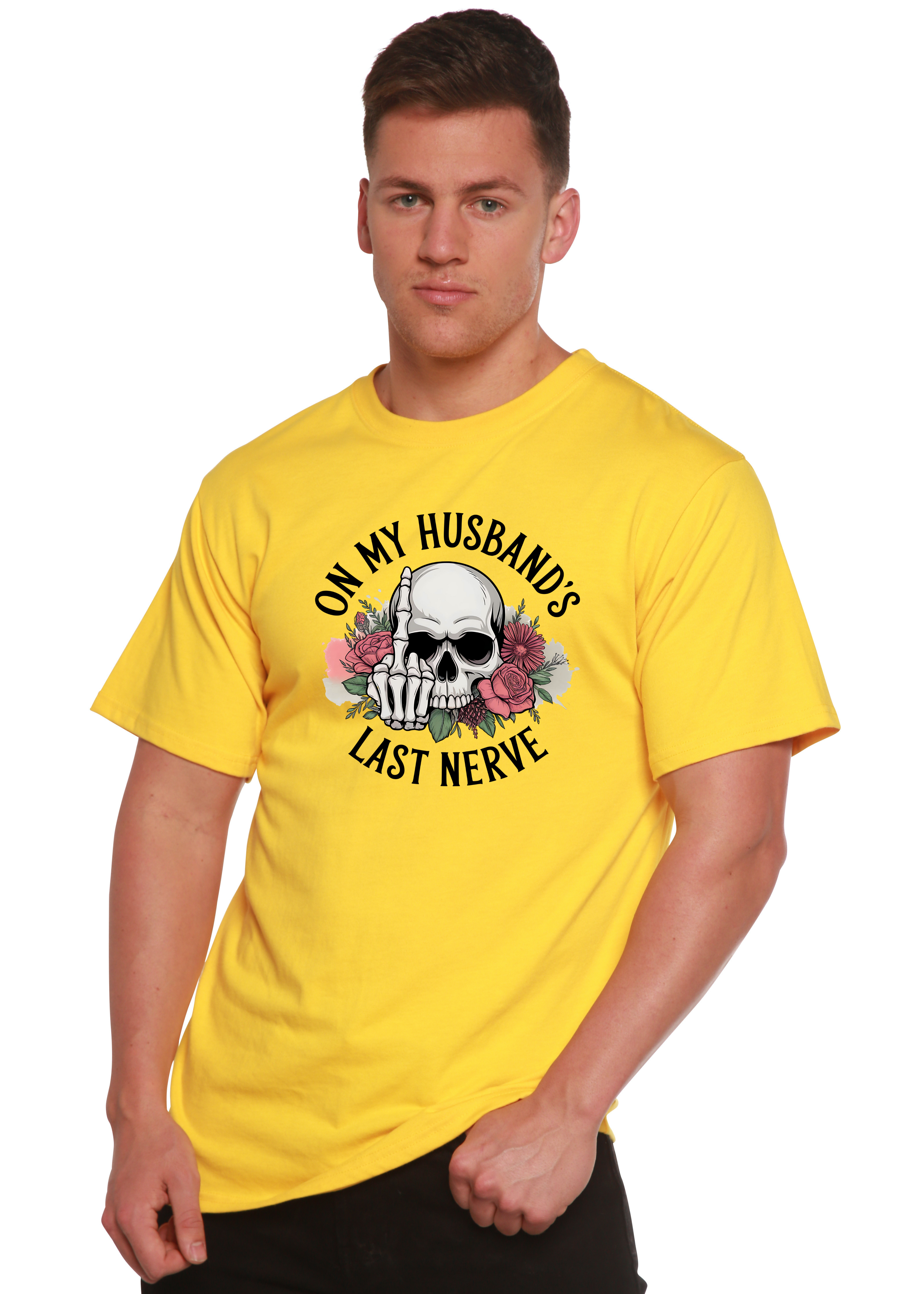 Man wearing a yellow t-shirt with a skull design and text 'On my husband's last nerve' on a white background