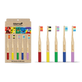 Set of colorful bamboo toothbrushes with packaging on a white background