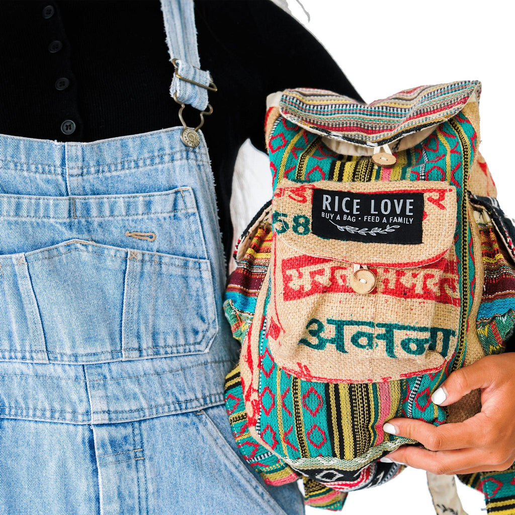 Person holding a colorful backpack with 'Rice Love' label