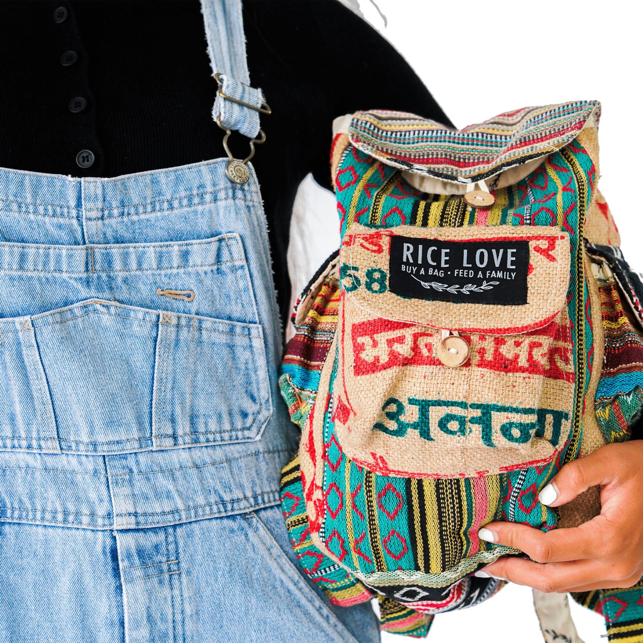 Person holding a colorful backpack with 'Rice Love' label