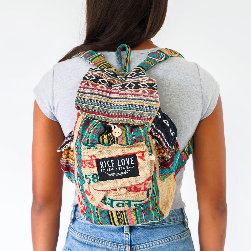 Person wearing a colorful backpack with 'Rice Love' label on a white background