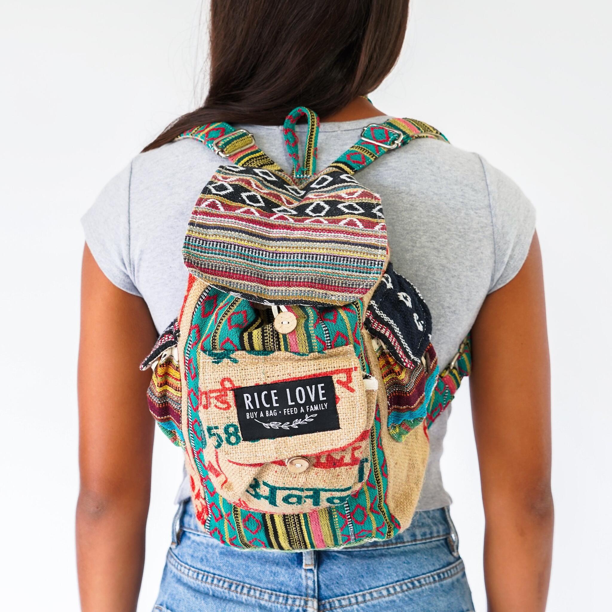 Person wearing a colorful backpack with 'Rice Love' label on a white background