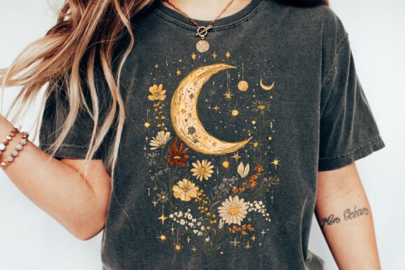 Person wearing a t-shirt with a moon and floral design on a plain background