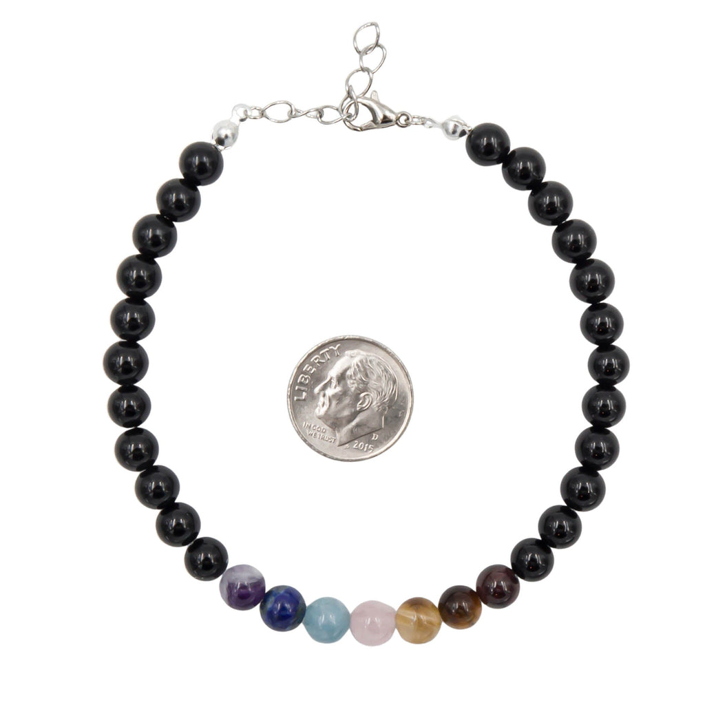 Black beaded bracelet with multicolored beads, shown with a quarter for scale on a white background