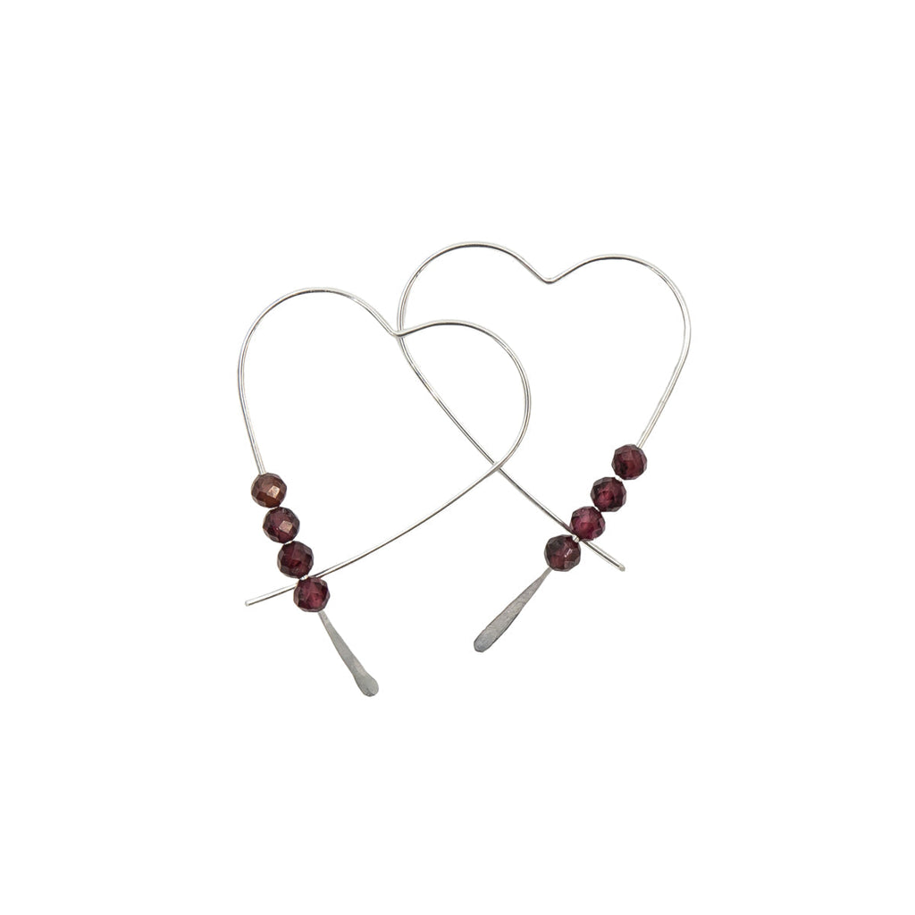 Heart-shaped earrings with red beads on a white background