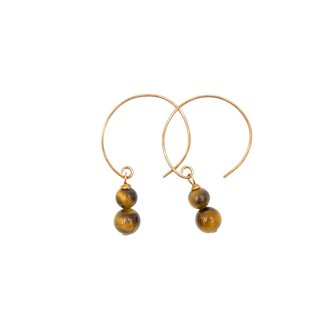 Gold hoop earrings with tiger's eye beads on a white background