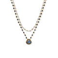 Necklace with a teardrop pendant on a white background