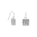 Pair of silver earrings with stamped fern design on a white background