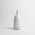 White essential oil diffuser on a light gray background