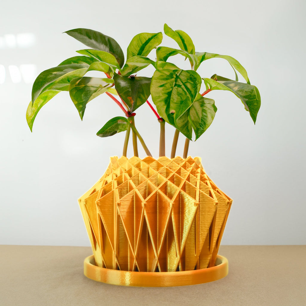 Geometric yellow 3D printed pot with green plant on a beige surface