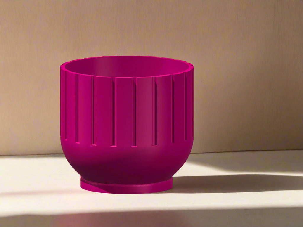 Pink planter with textured design on a beige background