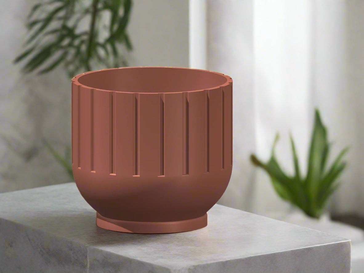 Brown planter on a marble surface with plants in the background