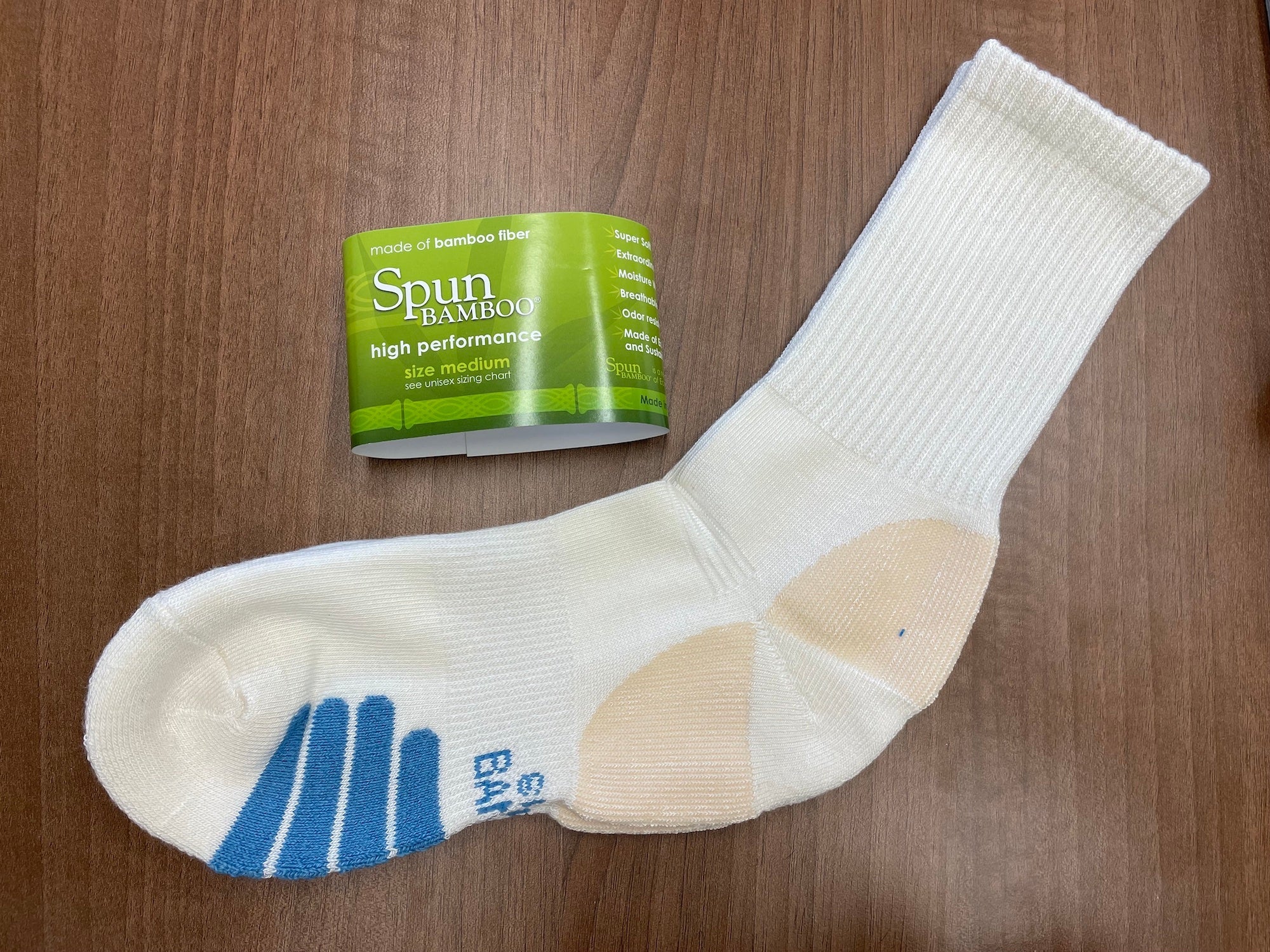 White sock with blue and beige accents on a wooden surface