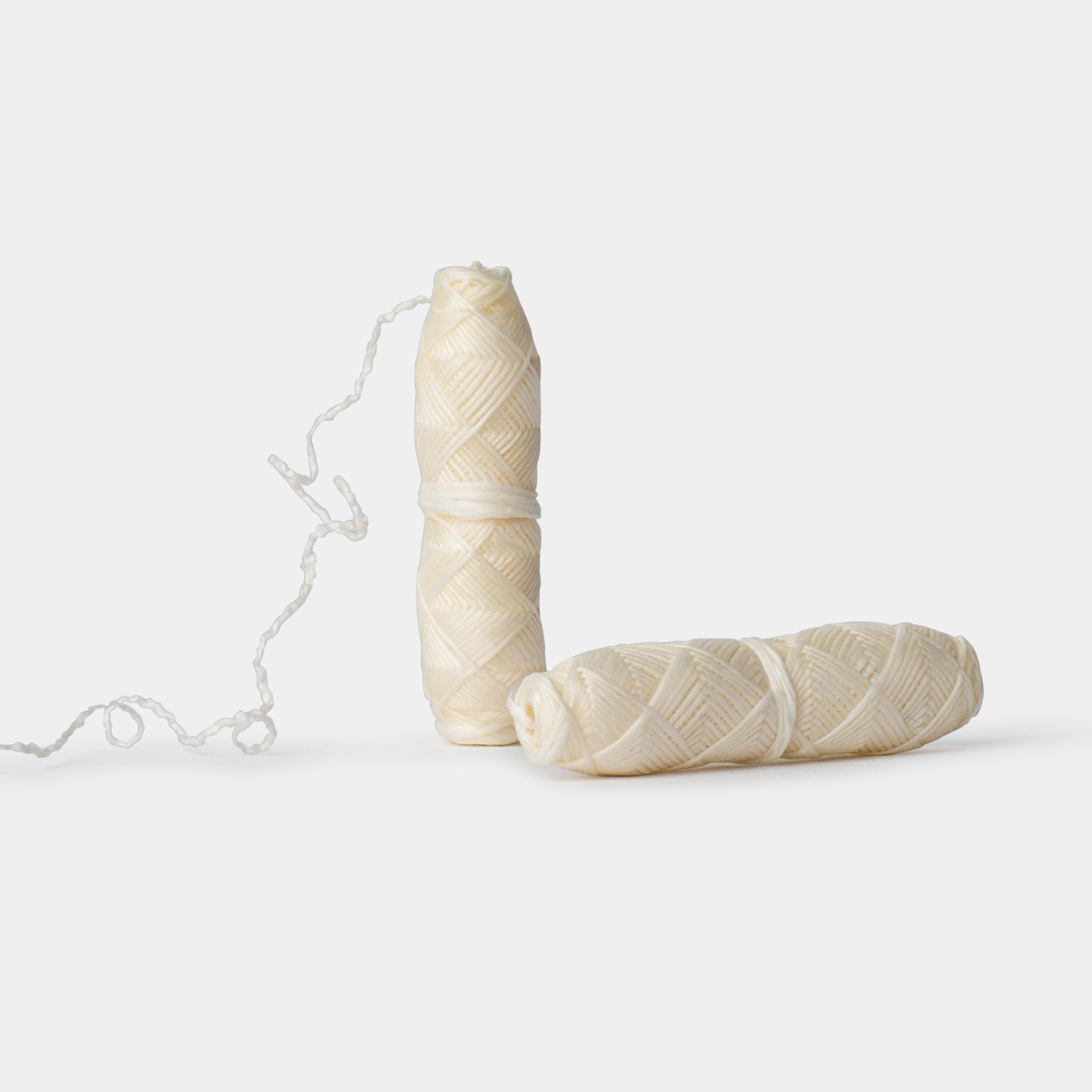 Two dental floss refills on a white background
