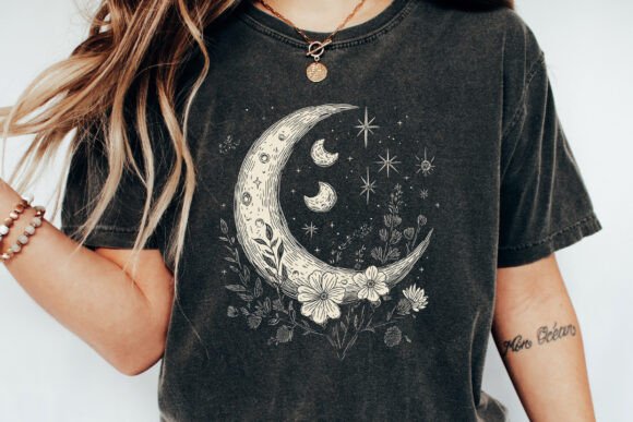 Person wearing a black t-shirt with a moon and star design.