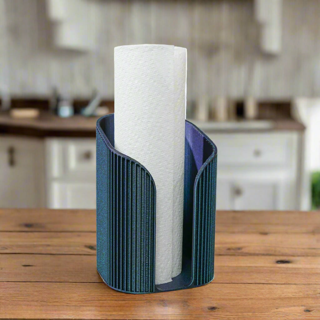 Blue paper towel holder with a roll of paper towels on a wooden table in a kitchen setting