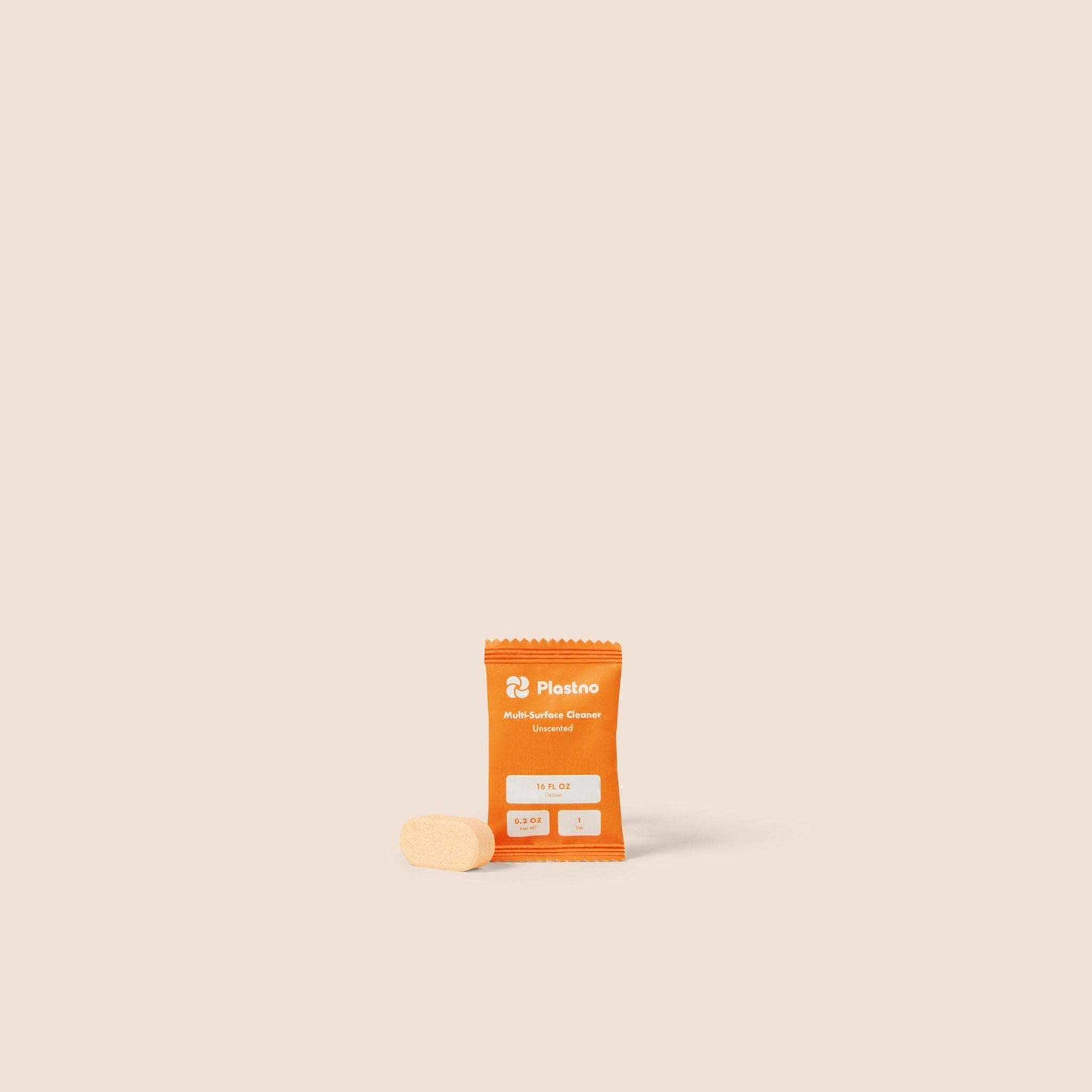 Orange supplement package with a white label on a beige background