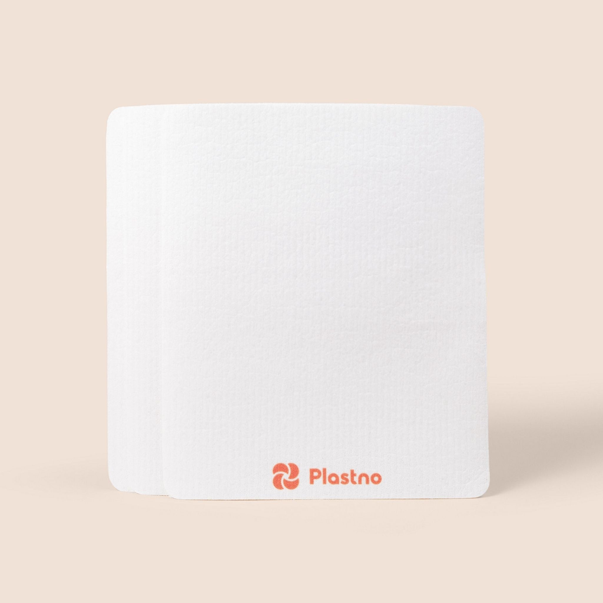 White rectangular sponge towel with 'Plastno' logo on a beige background
