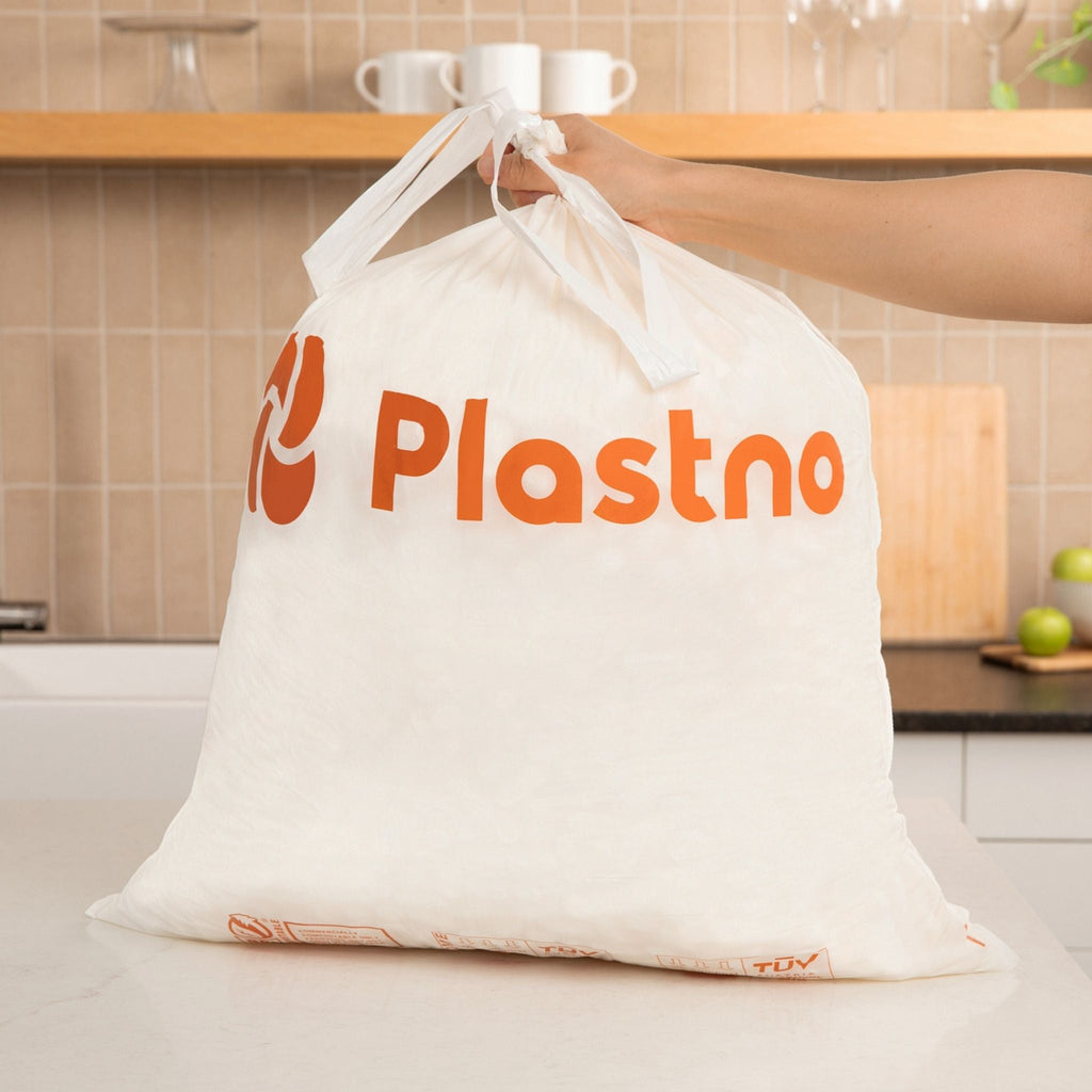 White drawstring bag with 'Plastno' branding held by a person in a kitchen.