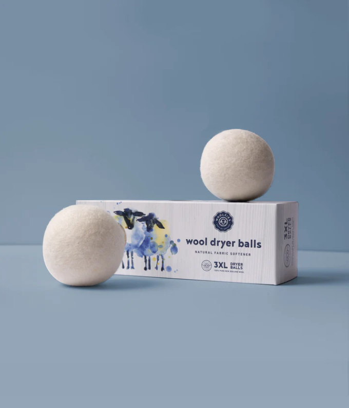 Wool dryer balls with packaging on a blue background