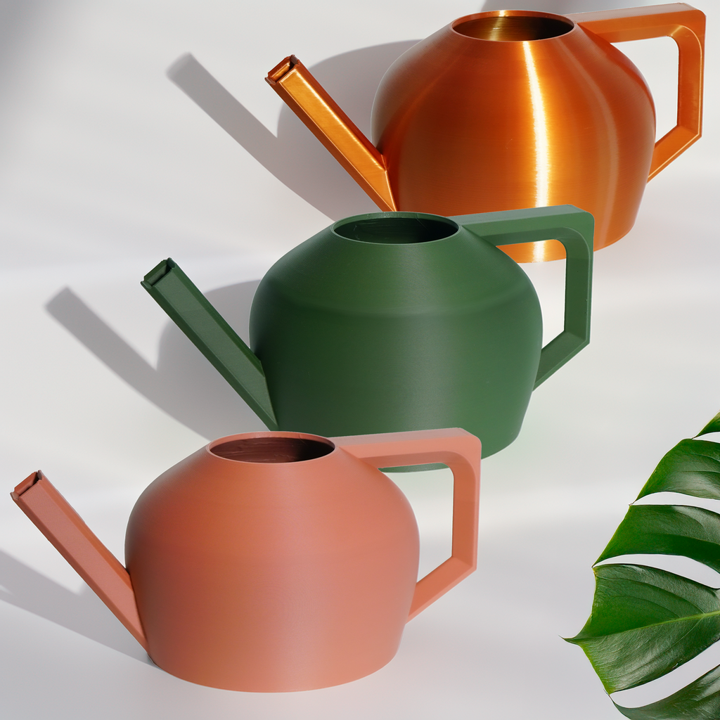 Three colorful watering cans on a white background with a leaf.