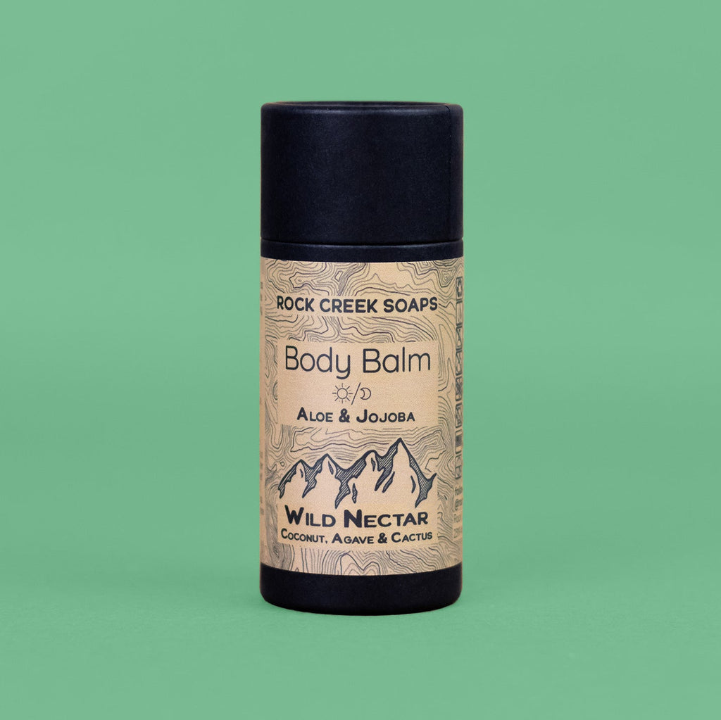 Body balm container with 'Rock Creek Soaps' branding on a green background