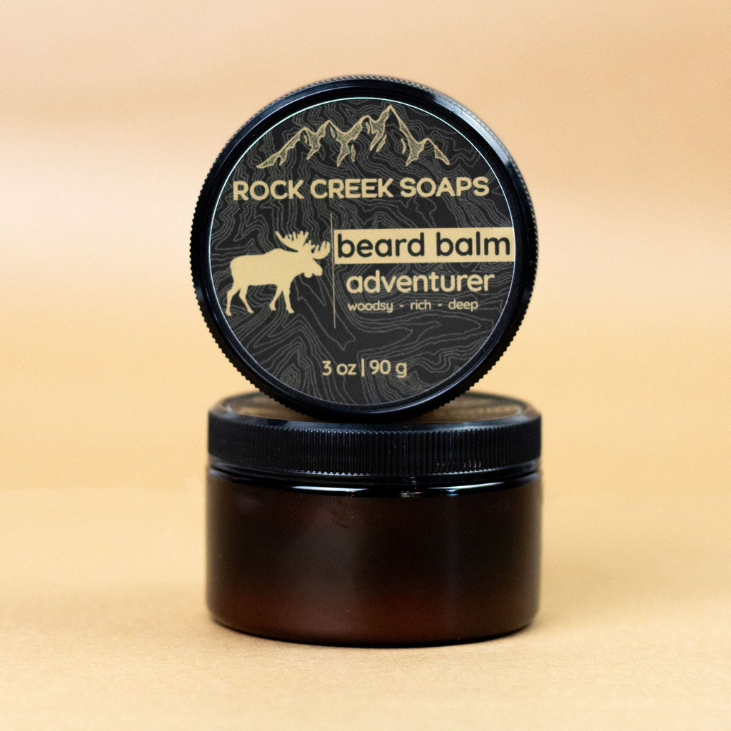 Rock Creek Soaps beard balm container on a beige background