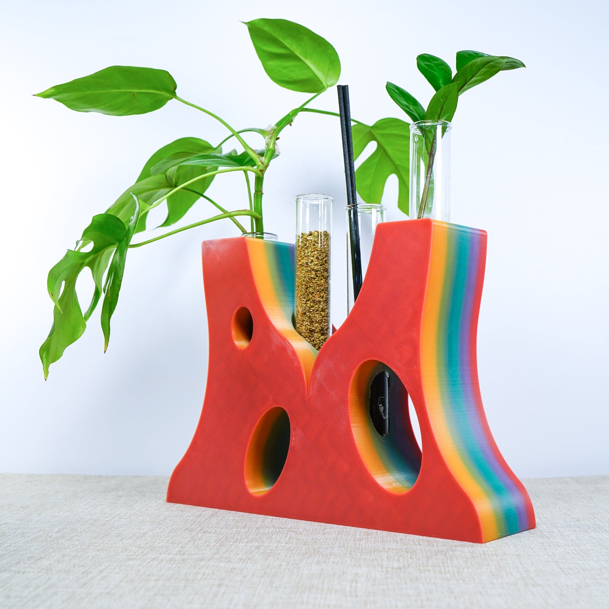 Colorful vase with plant cutouts on a white background