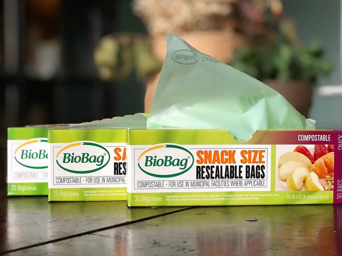 BioBag snack size resealable bags packaging on a wooden surface with a blurred background.