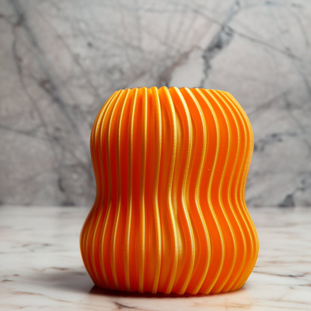 Orange textured vase on a marble surface with a marble background