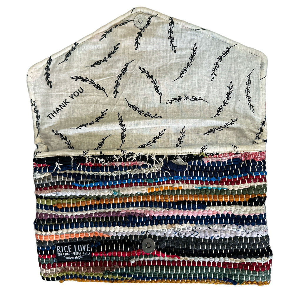 Multicolored woven pouch with embroidered text on a white background