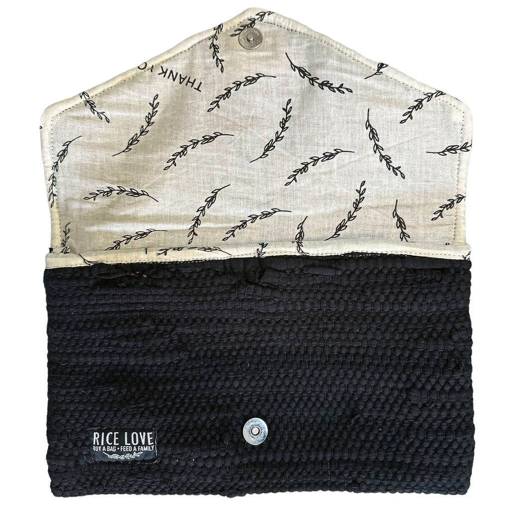 Black woven pouch with white fabric flap featuring black leaf pattern on a white background