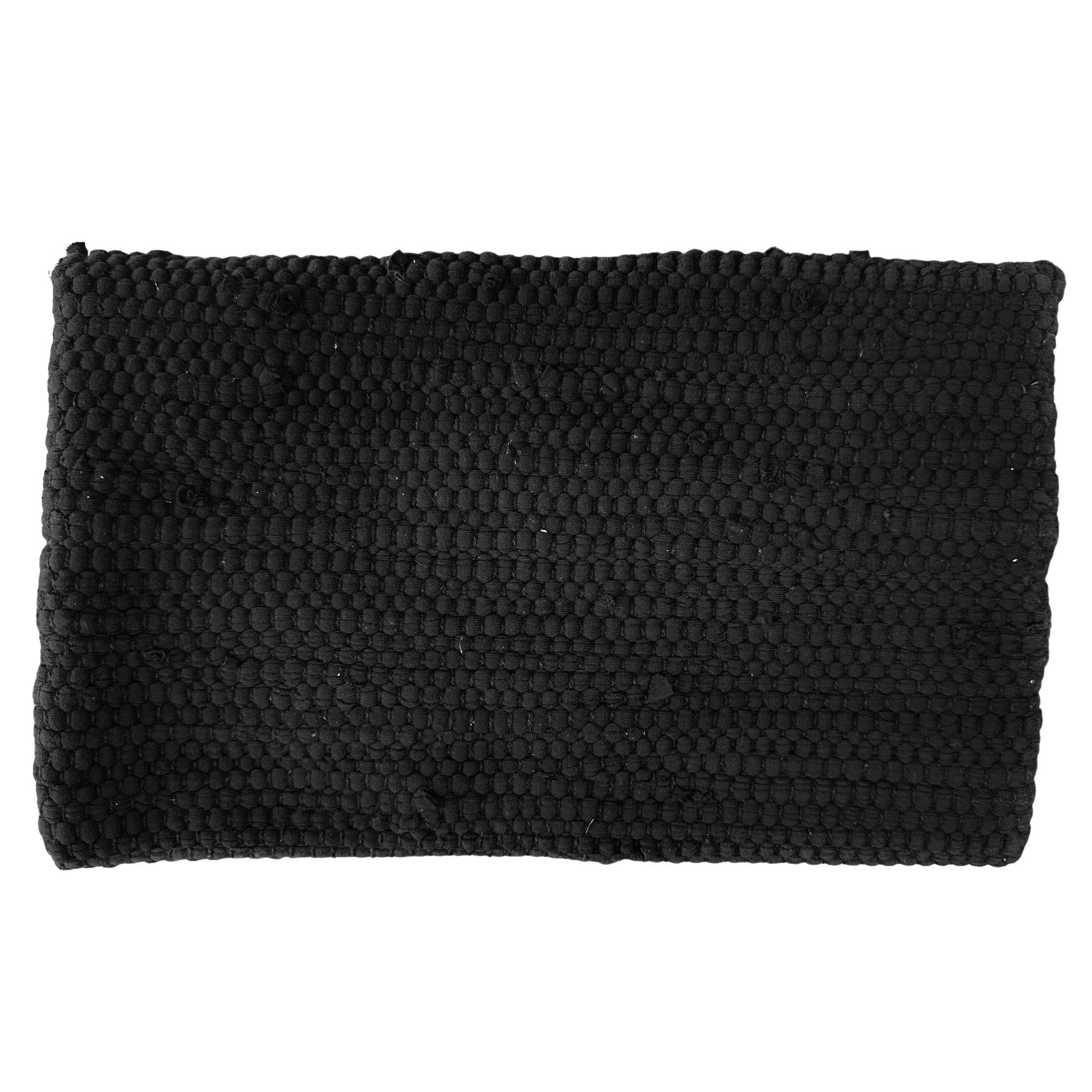Back of a black knitted clutch on a white background