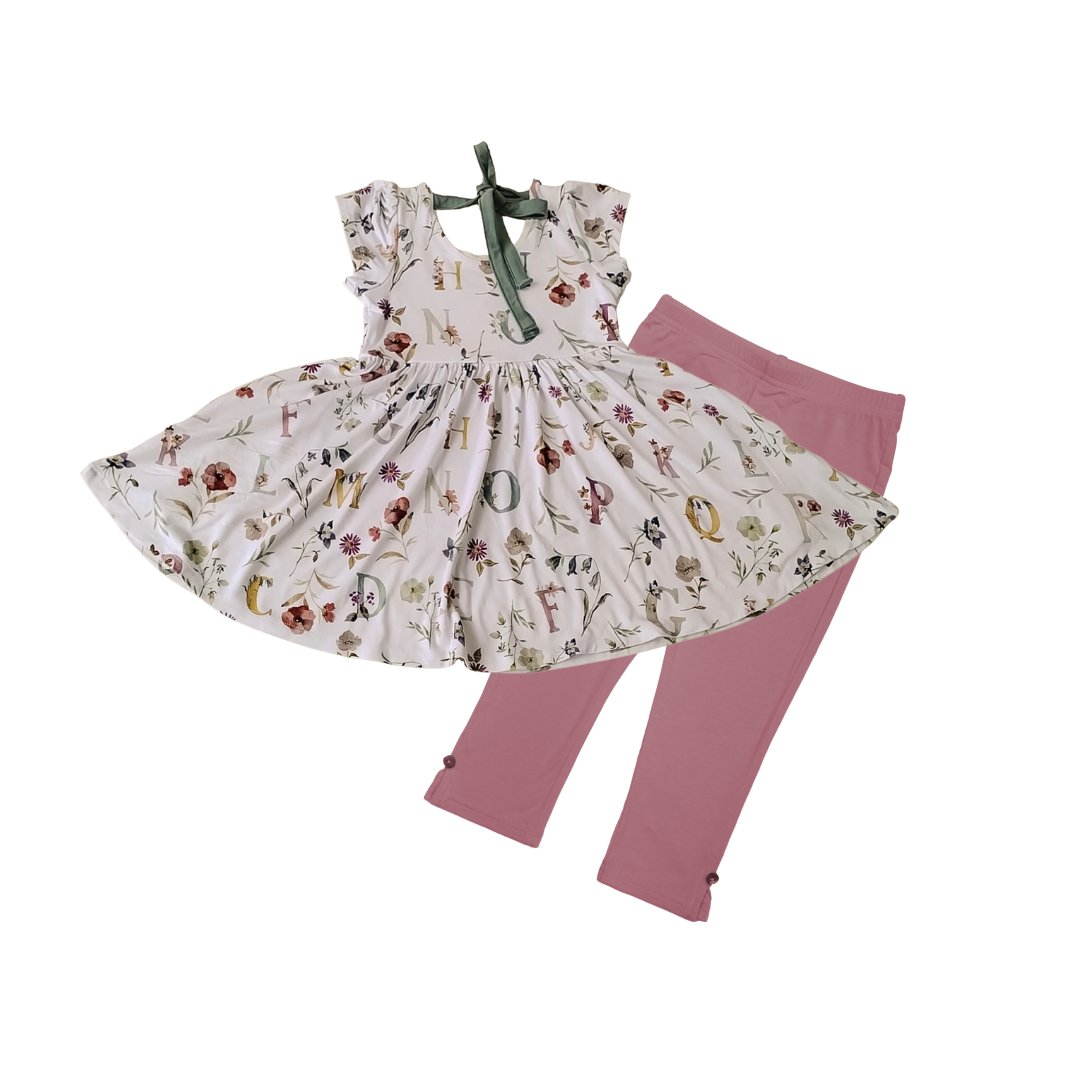 Children's dress and leggings set with floral pattern on a white background
